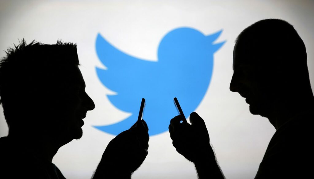 Image: Men are silhouetted against a video screen with an Twitter logo as he poses with an Samsung S4 smartphone in this photo illustration taken in the central Bosnian town of Zenica Image: Men are silhouetted against a video screen with an Twitter logo as he poses with an Samsung S4 smartphone in this photo illustration taken in the central Bosnian town of Zenica